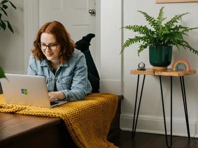 A person with possible ADHD lying on a bench with a yellow knit blanket, either in a focused work session or seeking online ADHD consultation